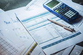 calculator financial documents and pen