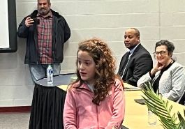  image of Mila being honored at UCS Board of Education meeting